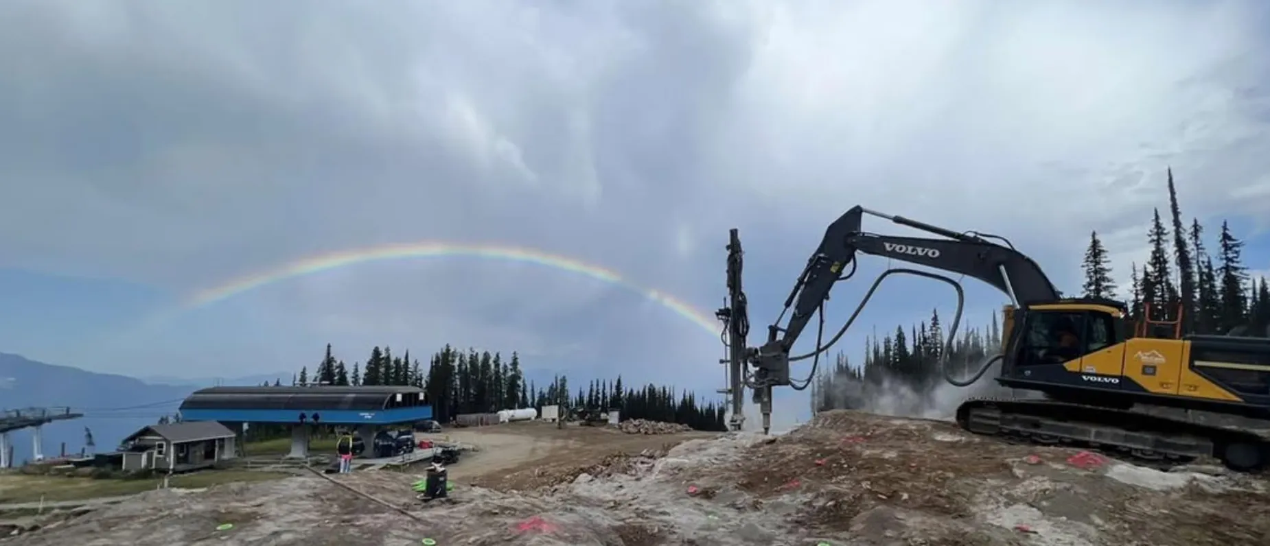 McCaw's drill rig and excavator working a rock cut at a BC ski hill